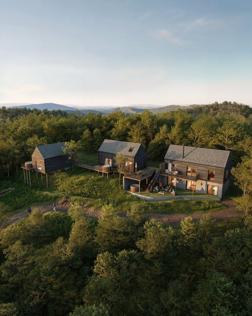 Aerial view rendering of three timber cabins on a forested hilltop at sunset