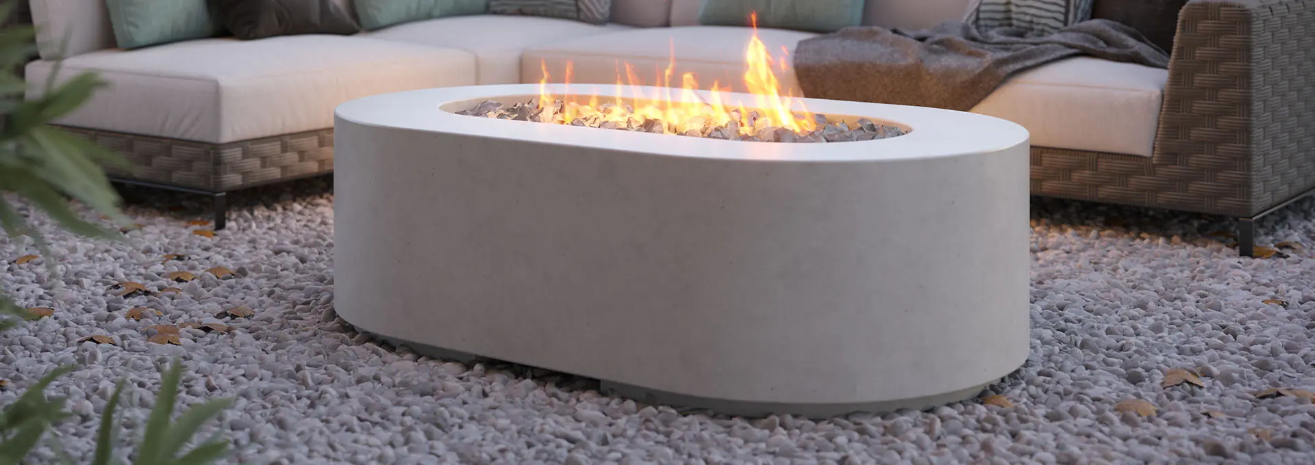 3D product rendering of an outdoor fire pit on a gravel patio with lounge furniture