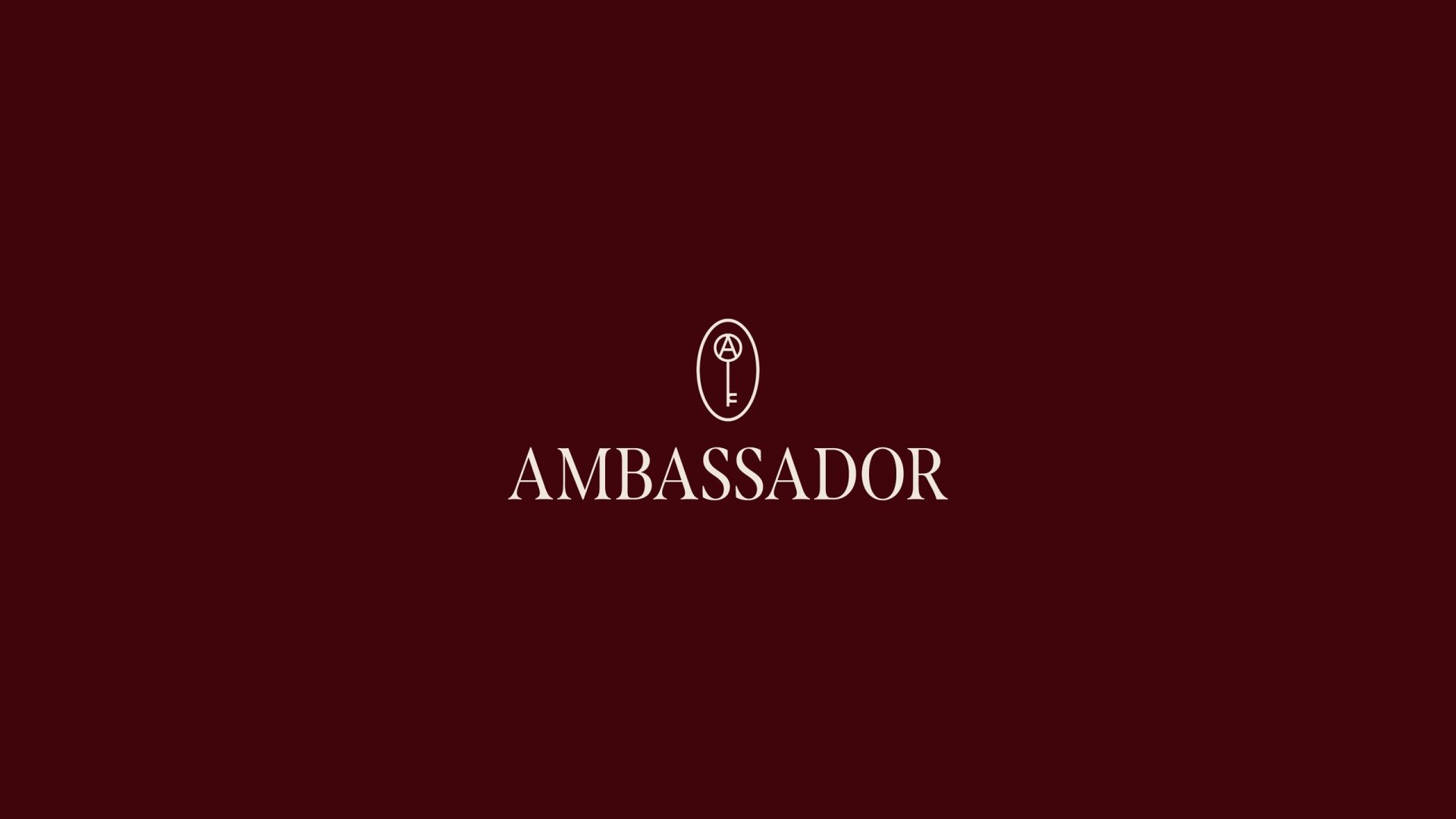 The Ambassador wordmark on burgundy